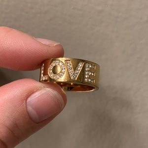 Rose gold toned Michael Kors “Love” ring